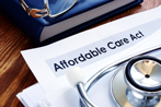 Affordable Care Act title on paper covered by stethescope