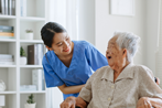 Young woman taking care of elderly hospice woman