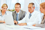 Physician and Business Executives Around Tabe